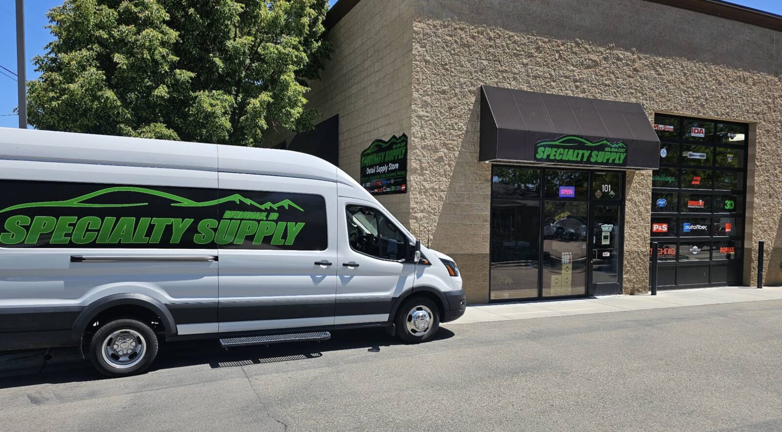 Specialty Supply wrapped delivery van parked at the Meridian storefront